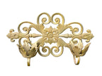 Decorative gold metal wall bracket on a gray background
