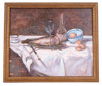 Still life painting with fish, wine glass, and bread on a tablecloth, framed in gold.
