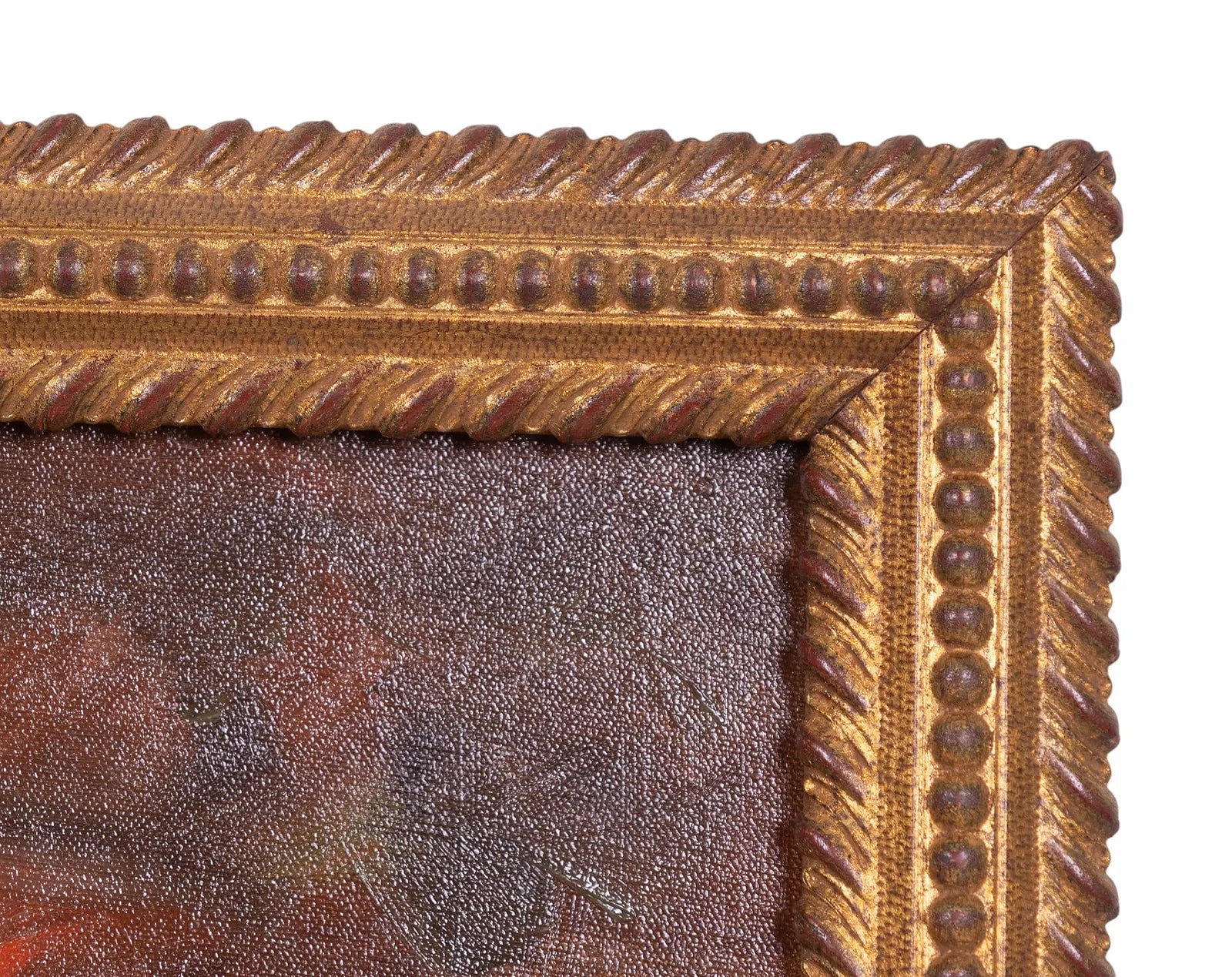 Close-up of a gold ornate picture frame with a textured surface.