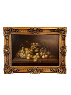 Decorative still life painting with fruits in a gold frame on a white background