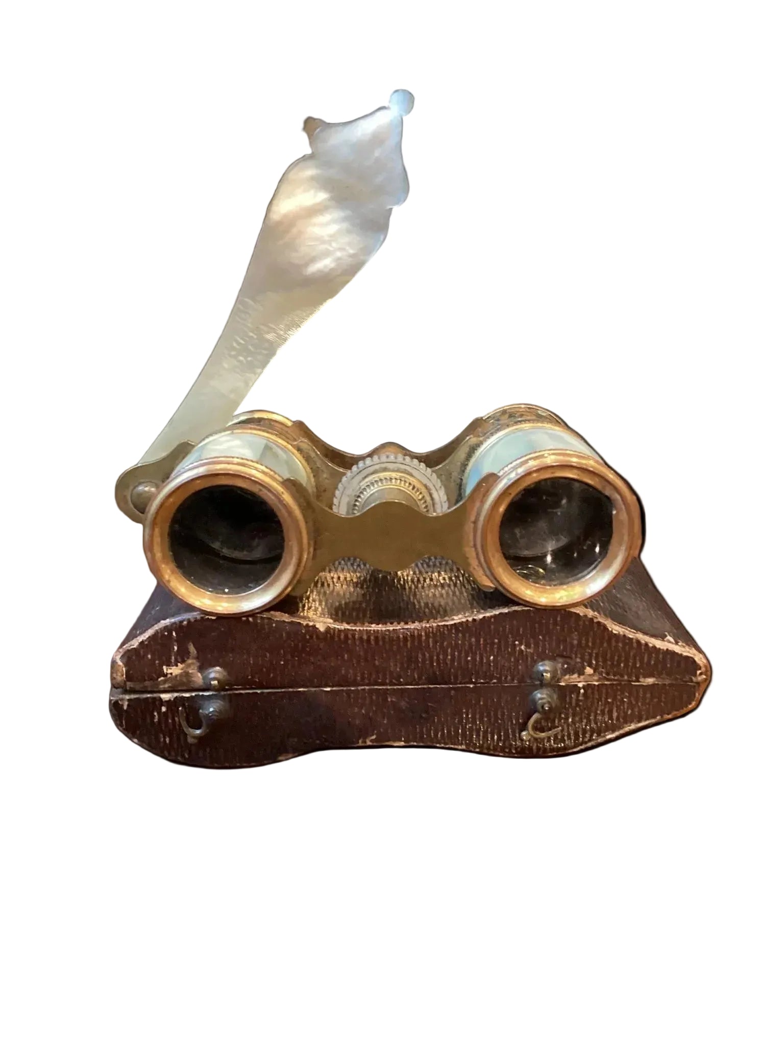 Vintage binoculars with ornate design on a wooden surface