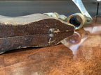 Vintage leather-bound book with metal clasps on a wooden surface