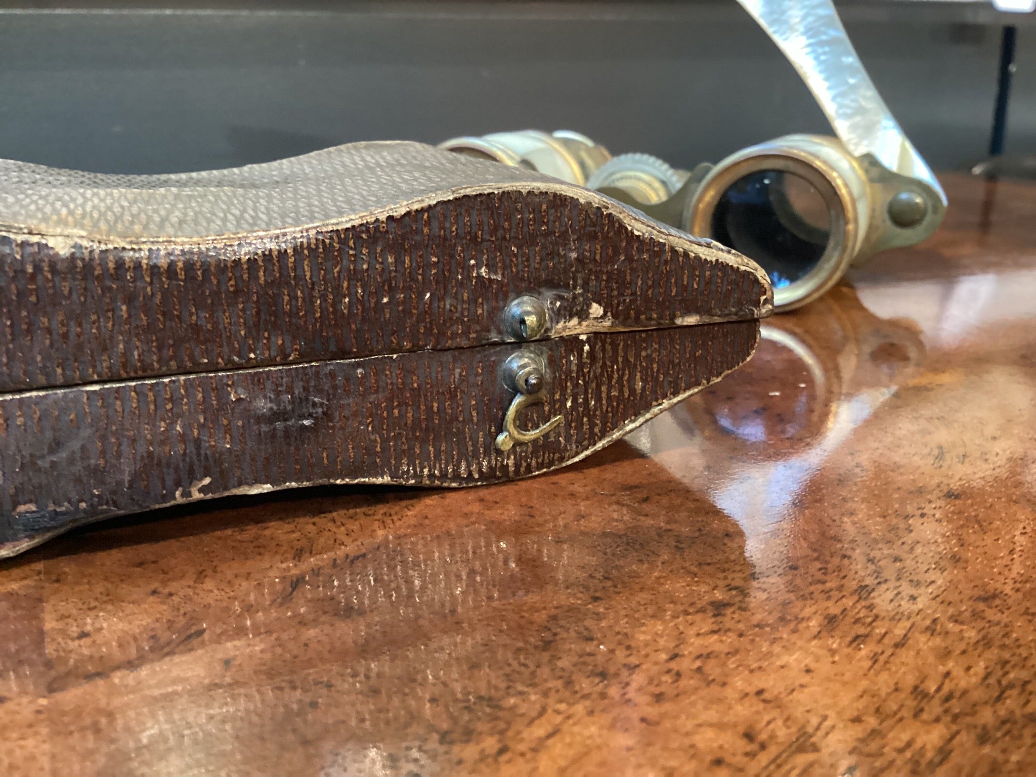 Vintage leather-bound book with metal clasps on a wooden surface