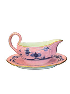 Pink floral teacup on a wooden surface