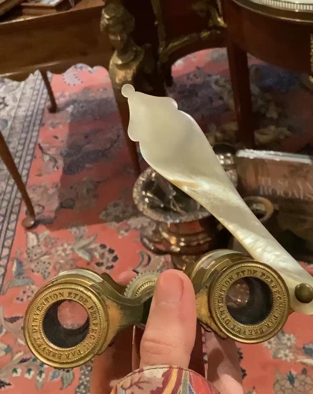 Video of mother of pearl opera glasses in someones hand